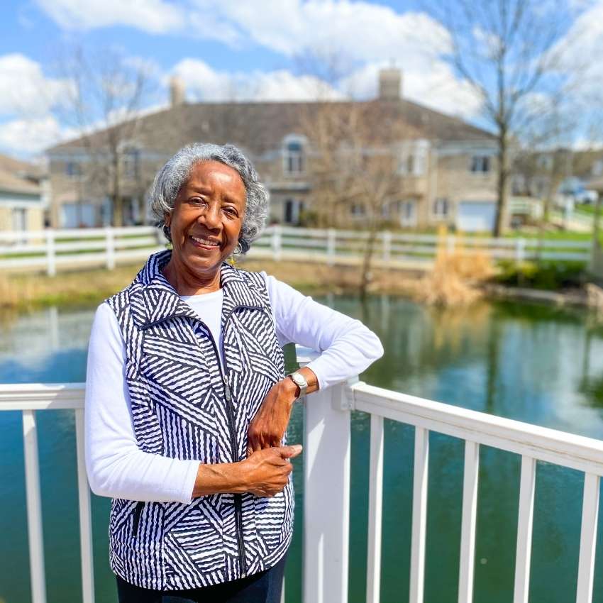 woman smiles by a pond